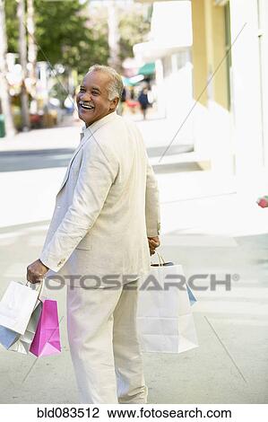Smiling Hispanic man shopping View Large Photo Image Stock Image - Smiling Hispanic man shopping. Fotosearch