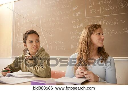 Stock Photograph - Students studying in classroom. Fotosearch