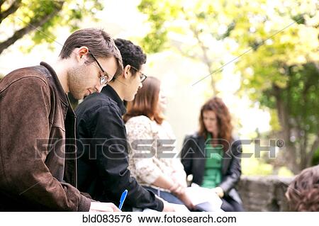 Stock Photograph - Students studying together outdoors. Fotosearch