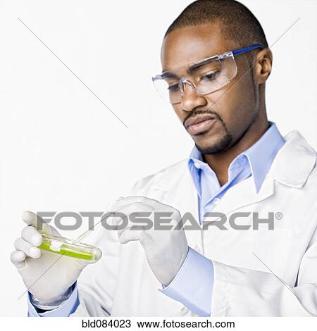 Stock Image - African American scientist working with petri dish. Fotosearch