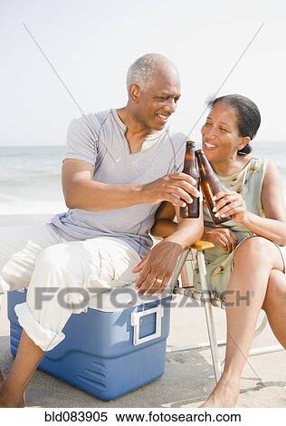 Black couple drinking beer on beach View Large Photo Image Stock Photography - Black couple drinking beer on beach. Fotosearch