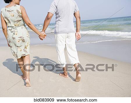 Stock Photo - Black couple enjoying beach together. Fotosearch