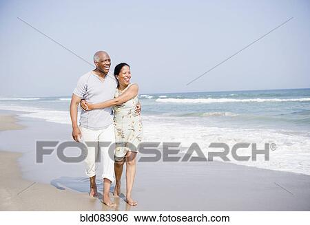 Stock Photograph - Black couple enjoying beach together. Fotosearch