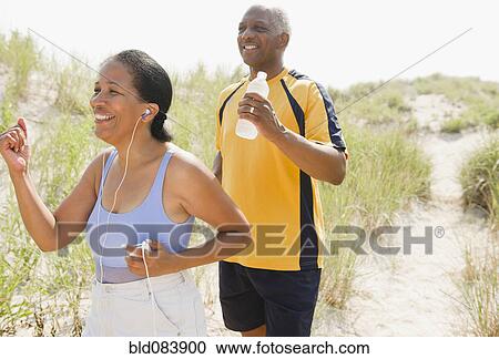 Black couple exercising on beach View Large Photo Image Stock Image - Black couple exercising on beach. Fotosearch
