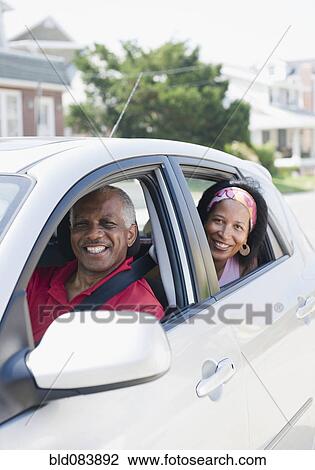 Stock Image - Black couple in car together. Fotosearch