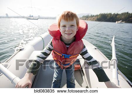 Caucasian boy rowing on boat View Large Photo Image Stock Photography - Caucasian boy rowing on boat. Fotosearch