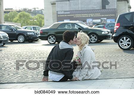 Caucasian man kissing girlfriend on busy street View Large Photo Image Stock Photo - Caucasian man kissing girlfriend on busy street. Fotosearch