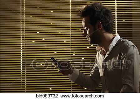 Caucasian man text messaging on cell phone at night View Large Photo Image Stock Image - Caucasian man text messaging on cell phone at night. Fotosearch