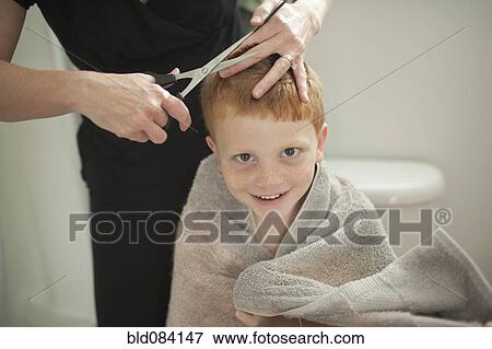Stock Photo - Caucasian mother giving son haircut. Fotosearch