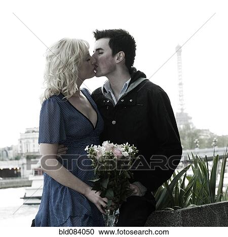 Caucasian woman holding bouquet and kissing boyfriend near Eiffel Tower View Large Photo Image Stock Image - Caucasian woman holding bouquet and kissing boyfriend near Eiffel Tower. Fotosearch