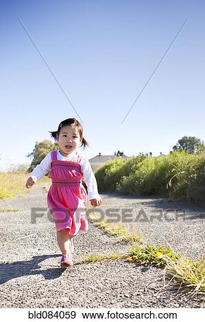 Chinese girl running on path View Large Photo Image Stock Photo - Chinese girl running on path. Fotosearch