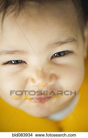 Grinning mixed race baby with messy face View Large Photo Image Picture - Grinning mixed race baby with messy face. Fotosearch