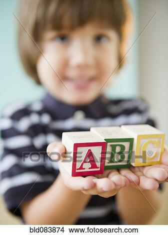 Hispanic boy holding alphabet blocks View Large Photo Image Picture - Hispanic boy holding alphabet blocks. Fotosearch