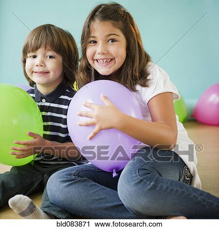 Hispanic brother and sister holding balloons View Large Photo Image Stock Image - Hispanic brother and sister holding balloons. Fotosearch