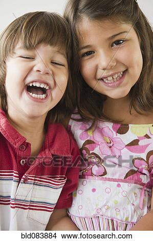 Picture - Hispanic brother and sister smiling. Fotosearch