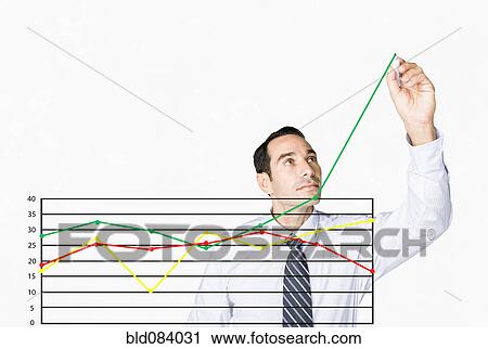 Stock Image - Hispanic businessman drawing chart on clear board. Fotosearch
