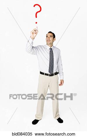Stock Photography - Hispanic businessman drawing question mark on clear board. Fotosearch