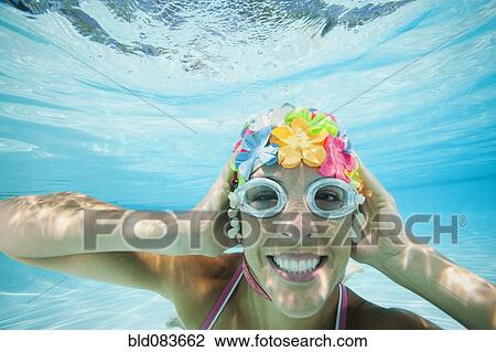 Hispanic woman in retro swimming cap underwater in swimming pool View Large Photo Image Stock Image - Hispanic woman in retro swimming cap underwater in swimming pool. Fotosearch