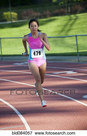 Stock Photo - Japanese relay runner running with baton. Fotosearch