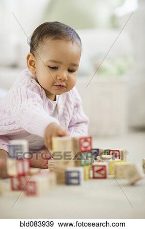 Stock Photo - Mixed race baby playing with blocks. Fotosearch