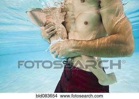 Mixed race father holding daughter in swimming pool View Large Photo Image Picture - Mixed race father holding daughter in swimming pool. Fotosearch