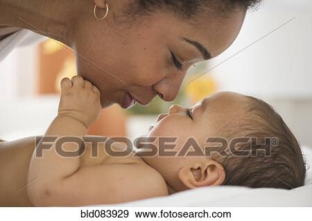 Mixed race mother talking to baby View Large Photo Image Stock Photo - Mixed race mother talking to baby. Fotosearch