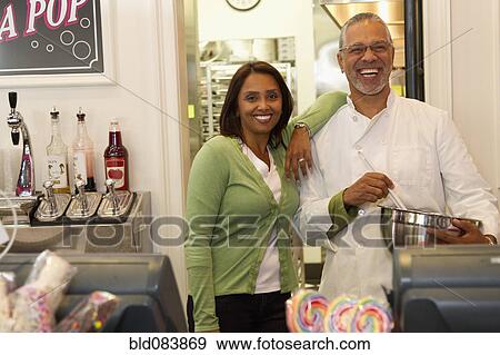 Small business owners standing in bakery shop View Large Photo Image Stock Photo - Small business owners standing in bakery shop. Fotosearch