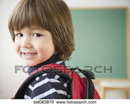 Stock Photo - Smiling Hispanic boy wearing backpack. Fotosearch