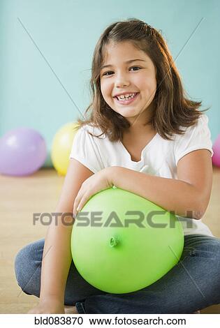 Smiling Hispanic girl holding balloon View Large Photo Image Stock Image - Smiling Hispanic girl holding balloon. Fotosearch