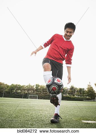 Asian soccer player practicing with ball on soccer field View Large Photo Image Stock Image - Asian soccer player practicing with ball on soccer field. Fotosearch