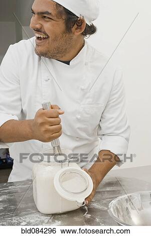 Baker working in bakery kitchen View Large Photo Image Stock Photograph - Baker working in bakery kitchen. Fotosearch