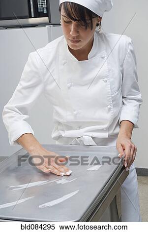 Baker working in bakery kitchen View Large Photo Image Stock Photography - Baker working in bakery kitchen. Fotosearch