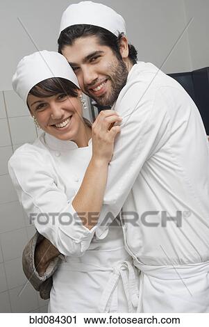 Bakers hugging in bakery kitchen View Large Photo Image Stock Image - Bakers hugging in bakery kitchen. Fotosearch