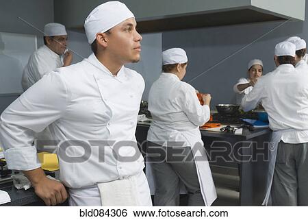 Stock Photograph - Bakers working in bakery kitchen. Fotosearch