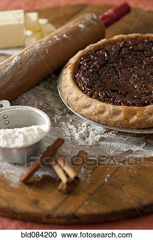 Stock Image - Baking ingredients and pecan pie. Fotosearch
