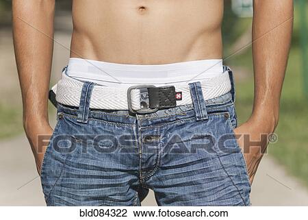Bare chested Hispanic man with hands in pockets View Large Photo Image Stock Image - Bare chested Hispanic man with hands in pockets. Fotosearch