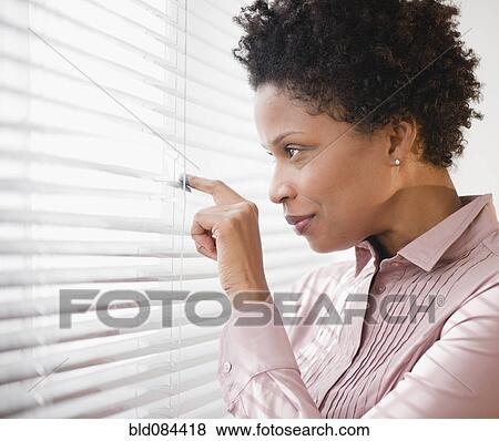 Black businesswoman looking out window View Large Photo Image Stock Photo - Black businesswoman looking out window. Fotosearch