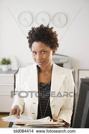 Picture - Black businesswoman working at desk. Fotosearch