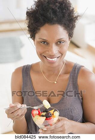 Black woman eating fruit salad View Large Photo Image Stock Photography - Black woman eating fruit salad. Fotosearch