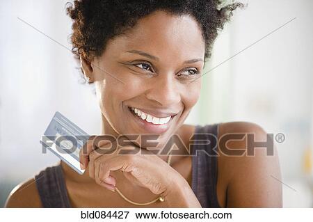 Black woman holding credit card View Large Photo Image Stock Photo - Black woman holding credit card. Fotosearch