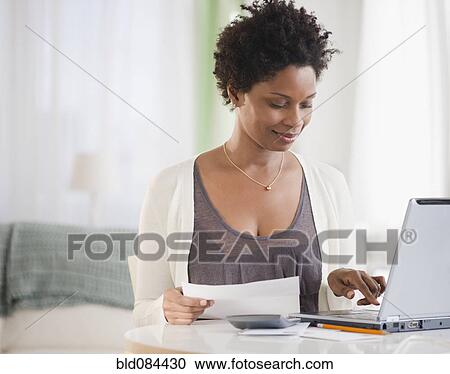 Black woman paying bills on computer View Large Photo Image Stock Image - Black woman paying bills on computer. Fotosearch