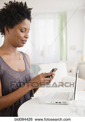 Black woman text messaging on cell phone View Large Photo Image Stock Photograph - Black woman text messaging on cell phone. Fotosearch