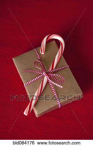 Candy can on top of Christmas gift View Large Photo Image Stock Photograph - Candy can on top of Christmas gift. Fotosearch