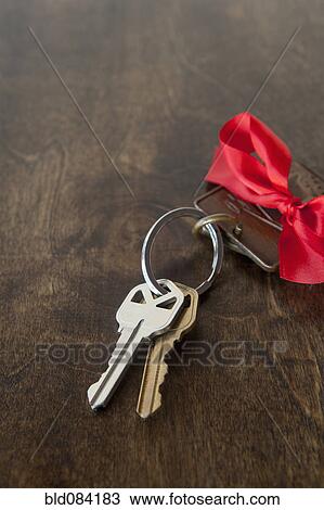 Stock Image - Car keys with red bow on key ring. Fotosearch
