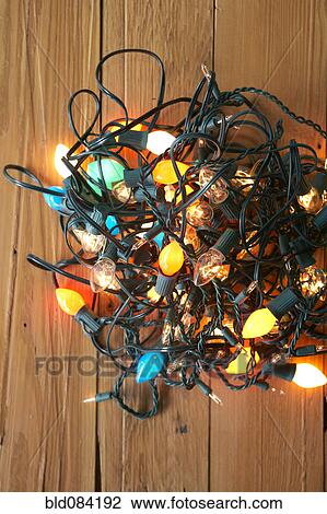 Stock Image - Glowing Christmas lights tangled on floor. Fotosearch