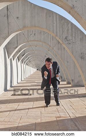 Stock Photography - Hispanic businessman cheering at success. Fotosearch