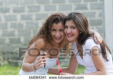 Hispanic friends hugging and eating ice cream together View Large Photo Image Stock Image - Hispanic friends hugging and eating ice cream together. Fotosearch