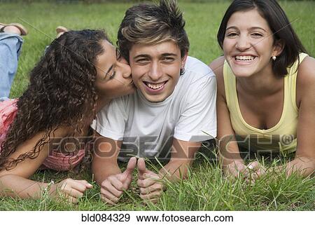 Stock Photo - Hispanic girl kissing man on cheek. Fotosearch