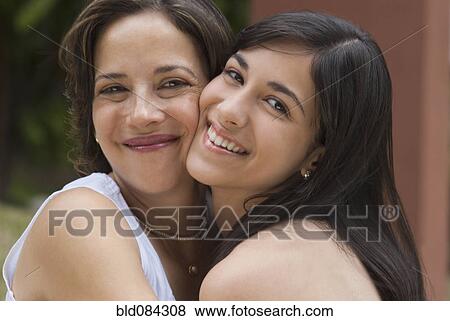 Stock Photo - Hispanic mother and daughter hugging. Fotosearch
