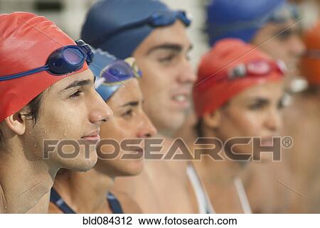 Stock Image - Hispanic swimmers standing in a row. Fotosearch